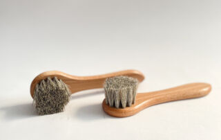Two hosehair dauber brushes on white background