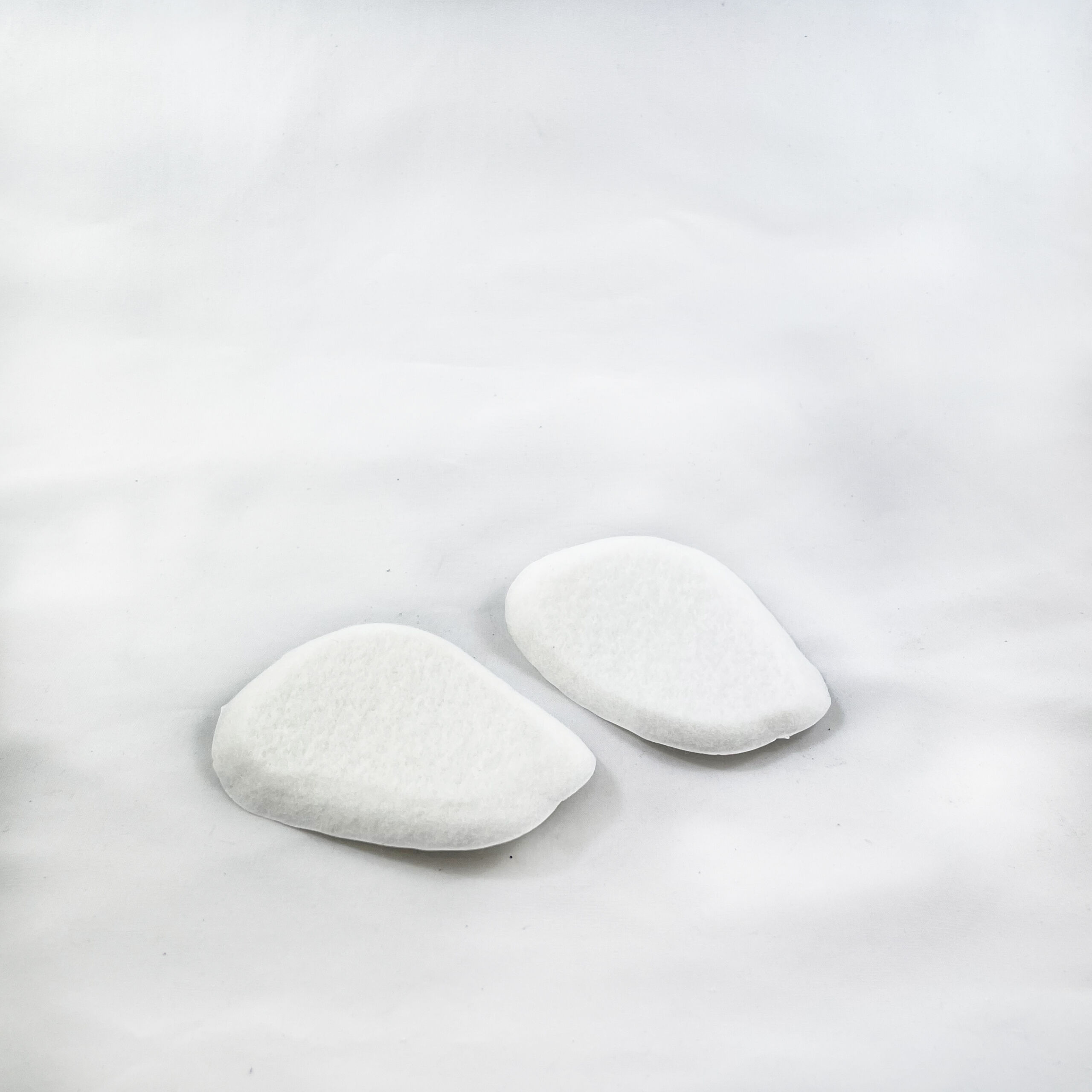 White felt tongue pads on white background